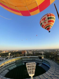 Hot air ballons flying over the MCG in Melbourne